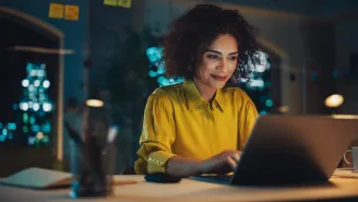 business woman working on laptop with confidence