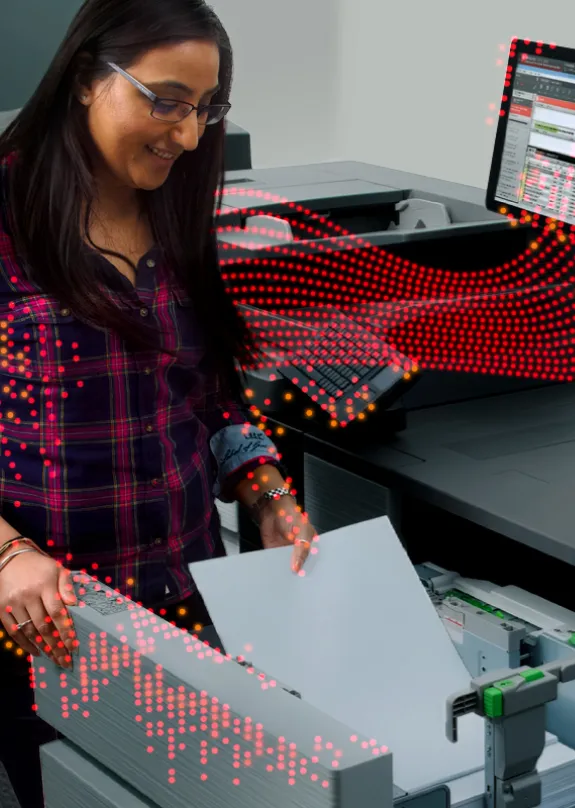 Woman putting paper into a Sharp MFP