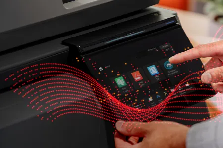 A close up of a man using the Synappx Cloud Print software installed on a printer